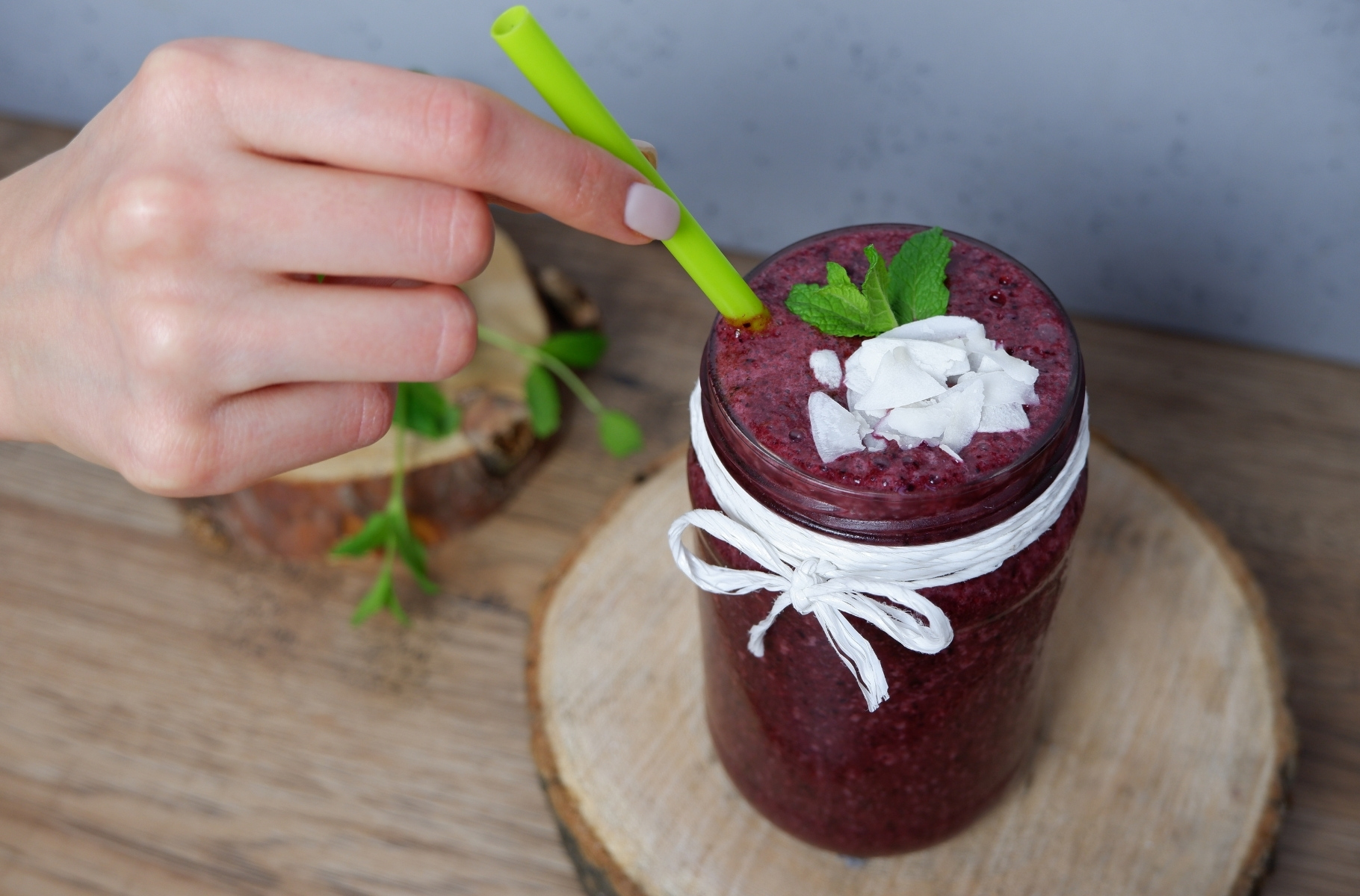 Blueberry Smoothie presented holding the straw
