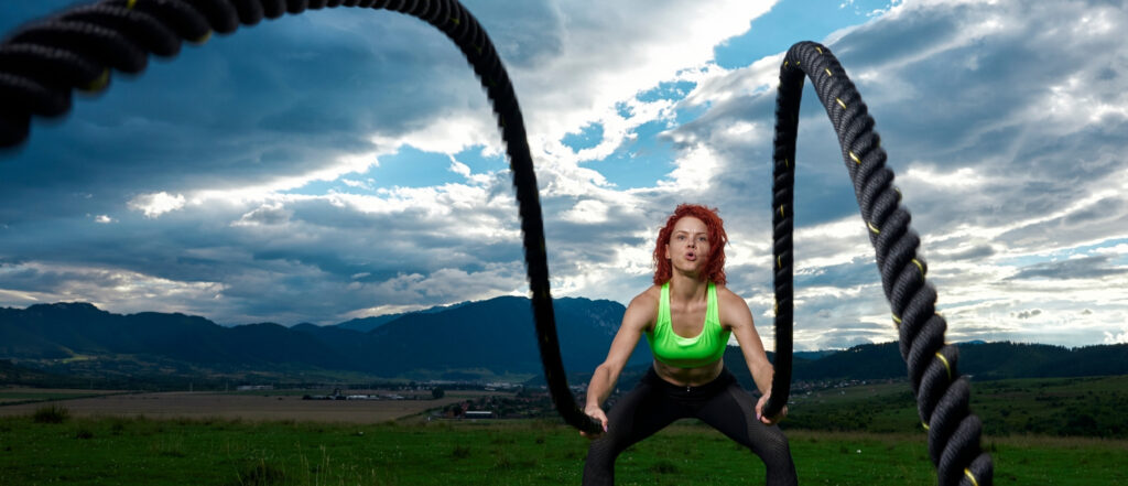 Battle ropes used by a women in outdoor Improving core stability and coordination