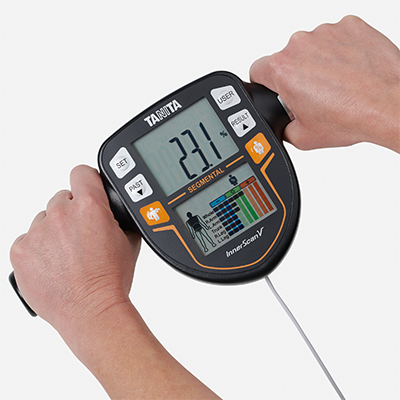 Hand display of the TANITA BC-545N showing body fat percentage.
