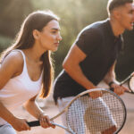 A couple enjoying a game of tennis together.