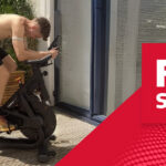 Physio Ben Lombard cycling on a Taurus IC70 Smart Indoor Bike at home, featured in a Fitshop article on injury recovery for runners